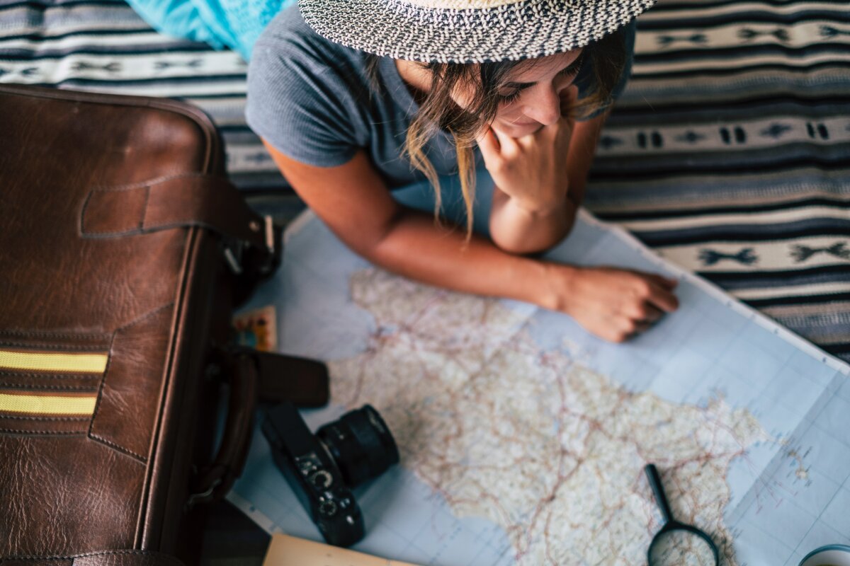 Traveller making travel plans looking at map 